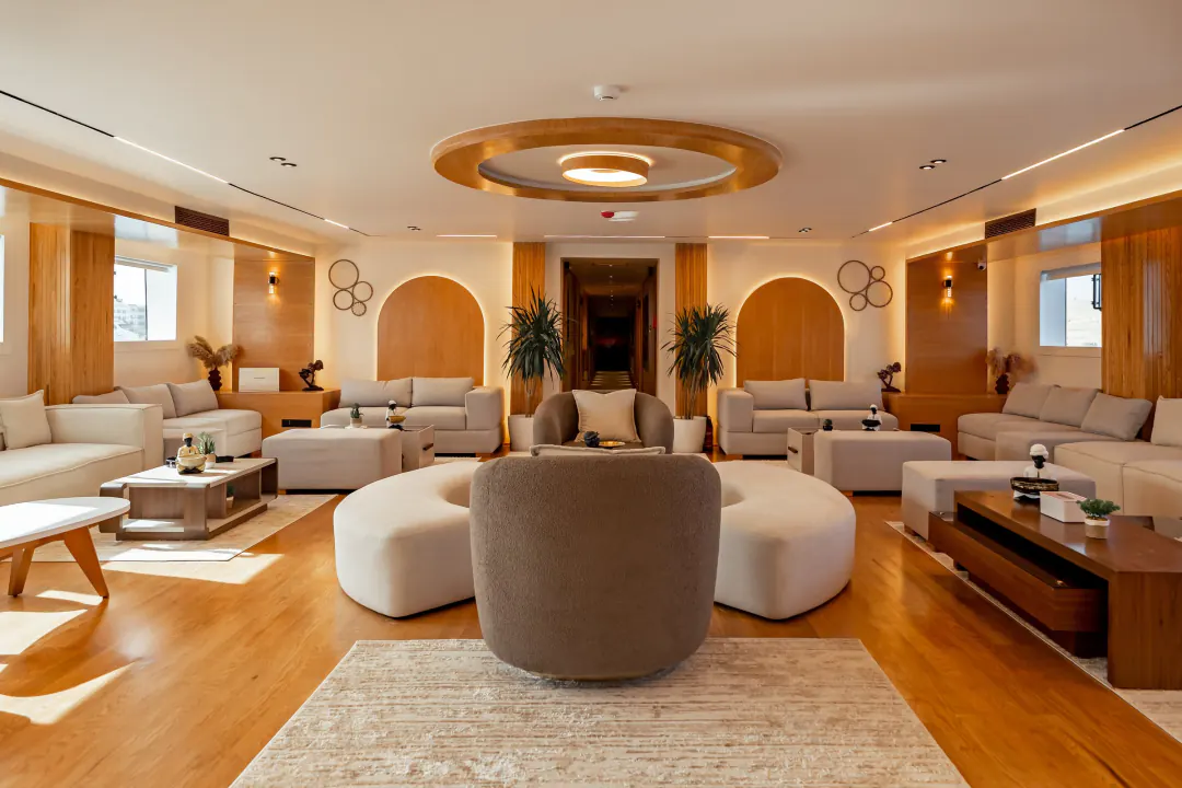Bright lounge with sofas, armchairs and curved upholstered seating