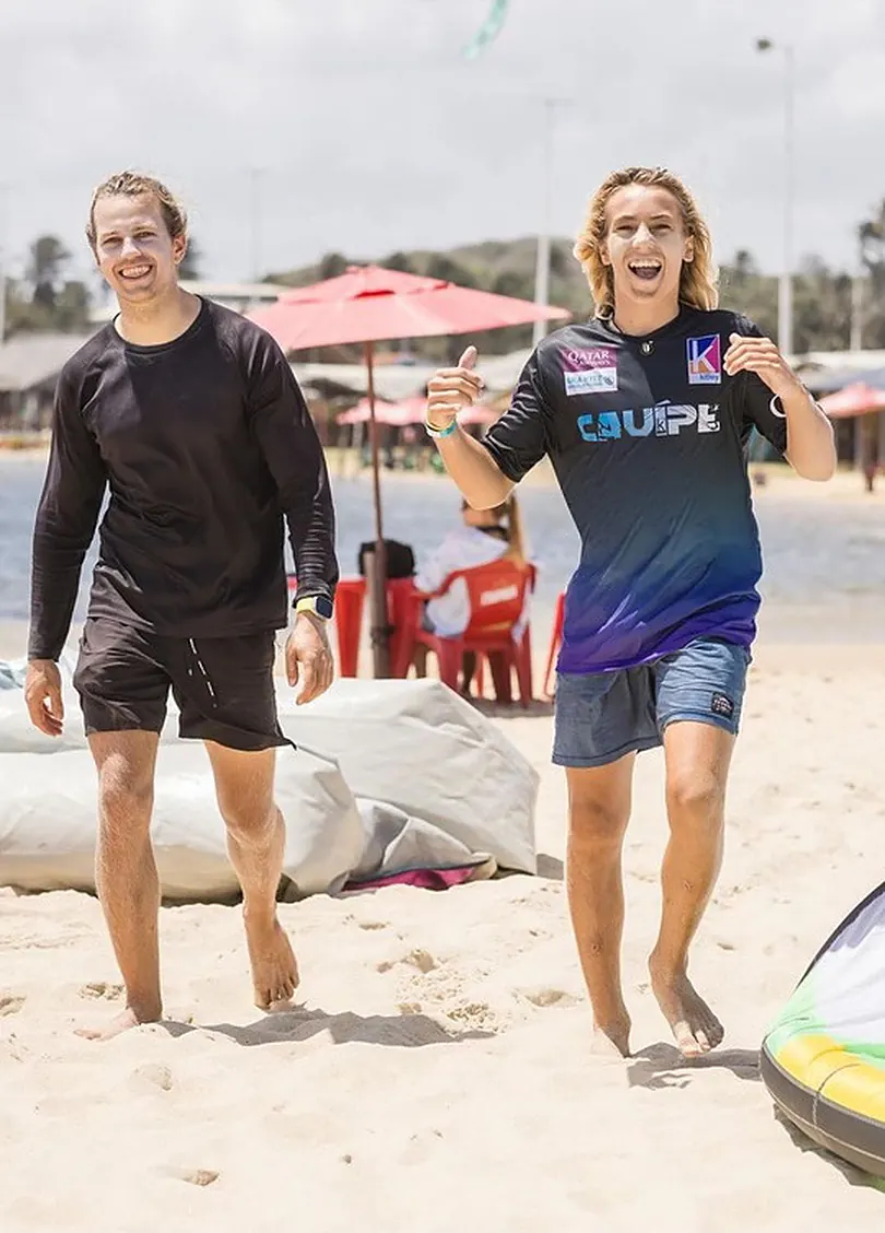Michael Soumbatov and Finn Flügel laughing as they walk along the beach at Lagoa do Cauípe in Brazil