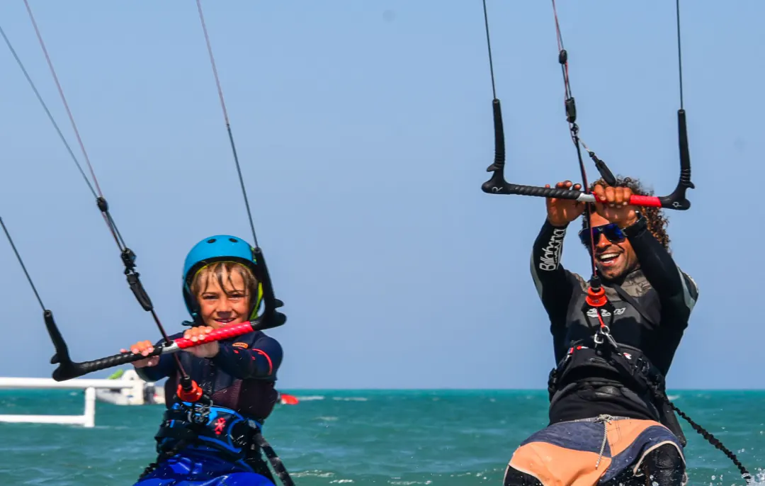 Finn as a child kiting with his coach Islam
